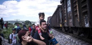 Venezuelan migrants boarding a freight train