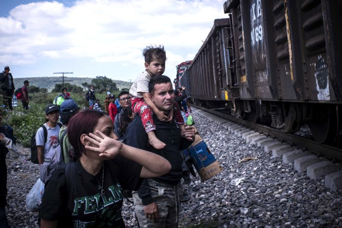 Venezuelan migrants boarding a freight train