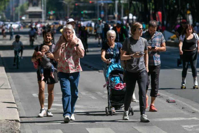 Tourists enjoy a Sunday walk on Paseo de la Reforma in Mexico City.