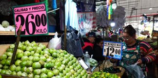 Green tomatoes and chiles for sale at a market