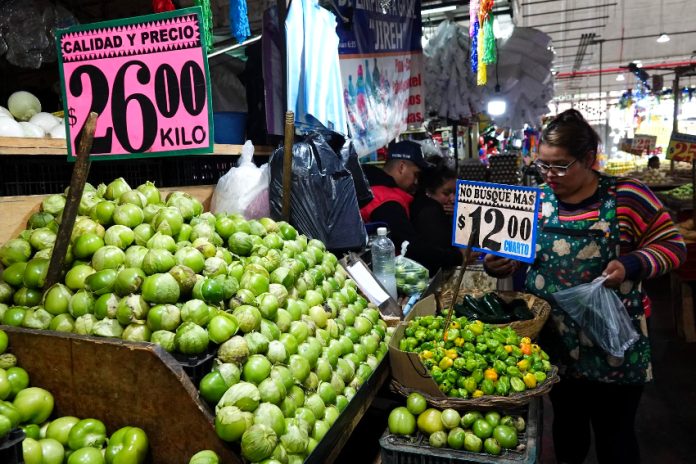 Green tomatoes and chiles for sale at a market