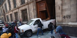 Protesters ramming a car through an entrance to Mexico City's National Palace on March 6, 2024