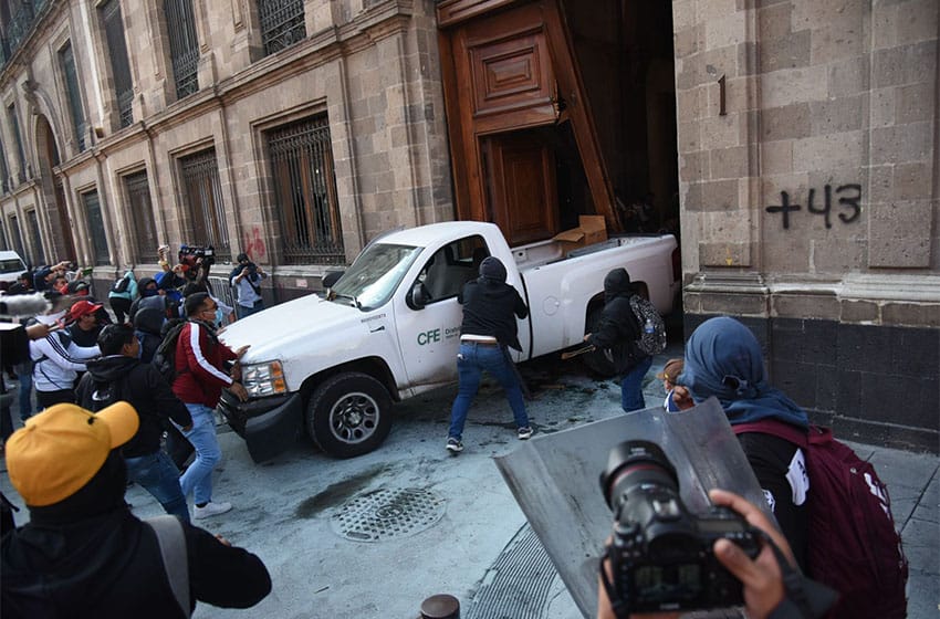 Protesters ramming a car through an entrance to Mexico City's National Palace on March 6, 2024
