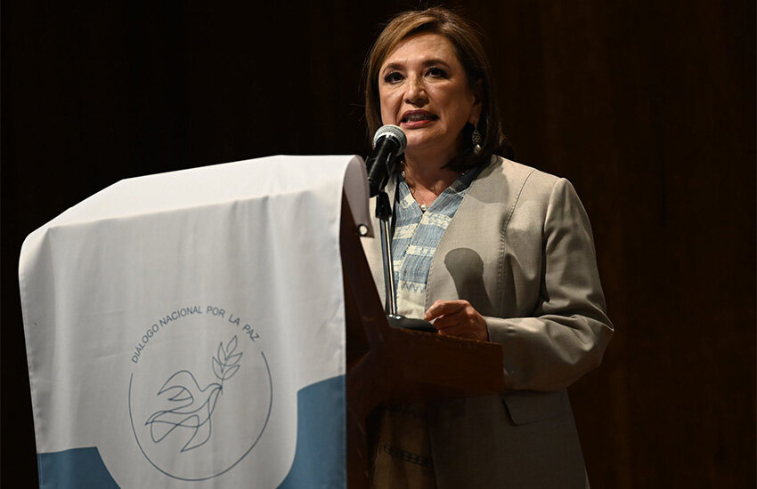 Mexico presidential candidate Xochitl Galvez stands at a podium speaking to Mexican Catholic bishops