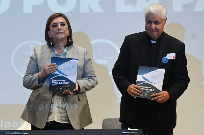 Mexico's presidential candidate Xochitl Galvez, left, stands with Rogelio Cabrera, head of the Mexican Episcopal Conference
