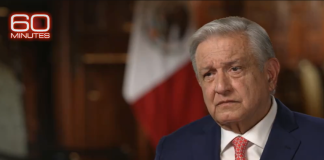 Mexican president Andrés Manuel López Obrador in from of a Mexican flag