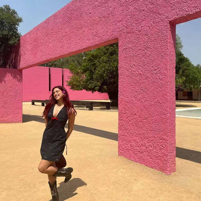 Pop star Dua Lipa posing in a courtyard in Mexico City