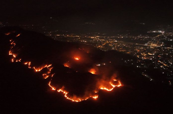 An aerial view of forest fires at night, outside the city of Acapulco