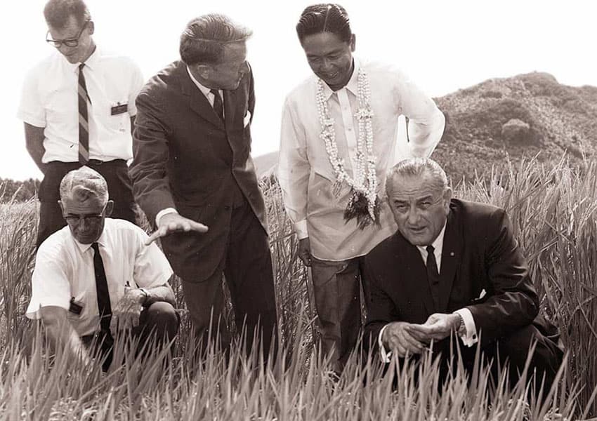agronomist John Borlaug and other men in a rice field somewhere in Asia