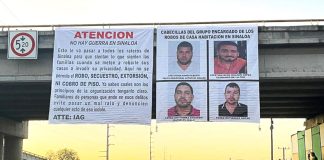 banners bearing messages in Spanish and hanging off a bridge