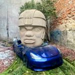 Olmec head vs Tesla car