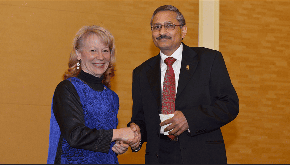 Photo of agricultural geneticist Ravi Singh and AAAS President Geraldine Richmond shaking hands