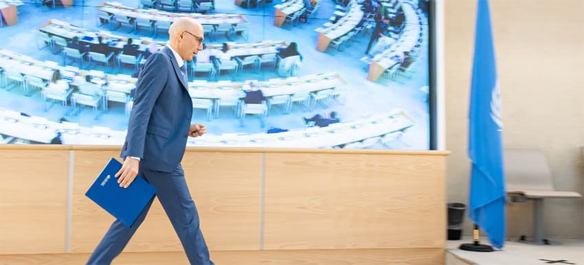 UN High Commissioner for Human Rights Volker Türk walks across a stage
