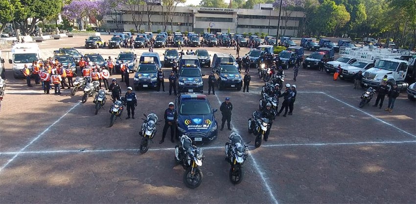 Police pose with their cars and motorcycles