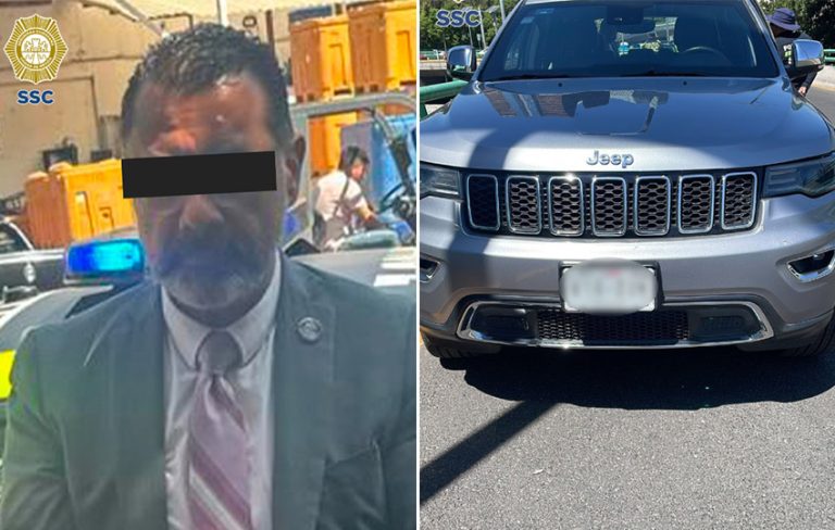 A police photo of a man in a suit with his eyes covered for anonymity