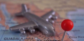 A toy plane sits on top of a map of Mexico
