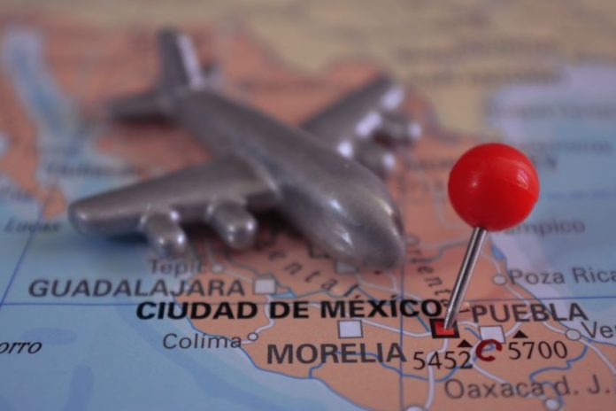 A toy plane sits on top of a map of Mexico