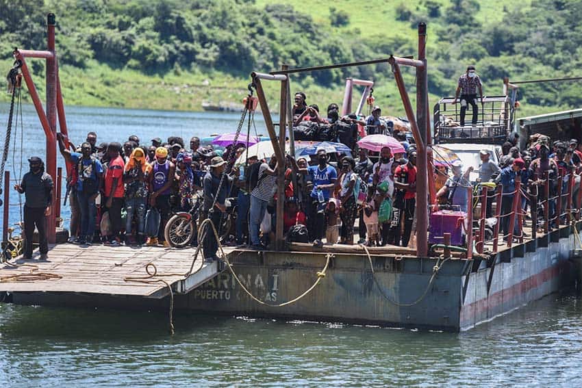 Migrants standing in a ferry crossing the Angostura reservoir in Chiapas