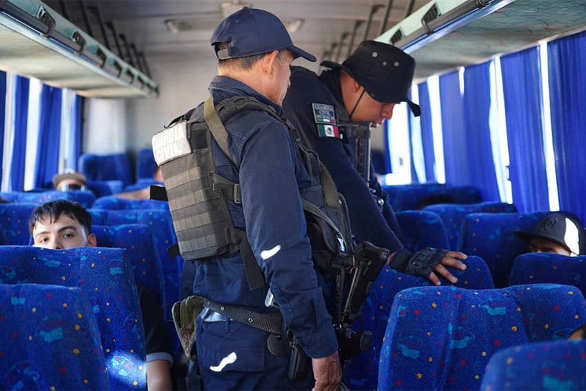 Michoacan police questioning a passenger on a long-distance bus