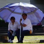 A couple brings their own shade to a Mexico City park in late March.