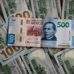 Mexican peso bill and US dollar bills