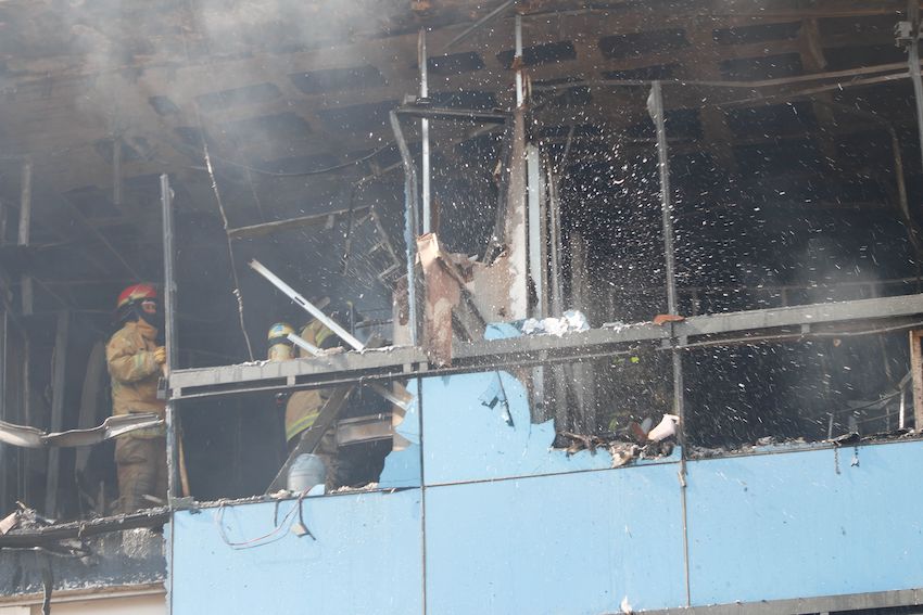 Firefighters put out a fire at the Montaña building of the state government complex in Chilpancingo on Monday