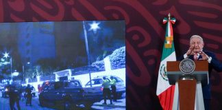 President Lopez Obrador of Mexico giving a press conference with a screen behind him