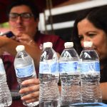 Mexicans examining bottles of drinking water
