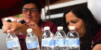 Mexicans examining bottles of drinking water