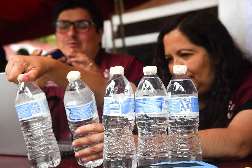Mexicans examining bottles of drinking water