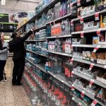 People buying bottled water from a supermarket
