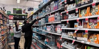 People buying bottled water from a supermarket