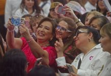Mexico presidential candidate Xochitl Galvez taking a selfie with a crowd of supporters