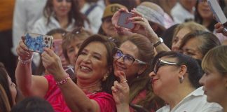 Mexico presidential candidate Xochitl Galvez taking a selfie with a crowd of supporters