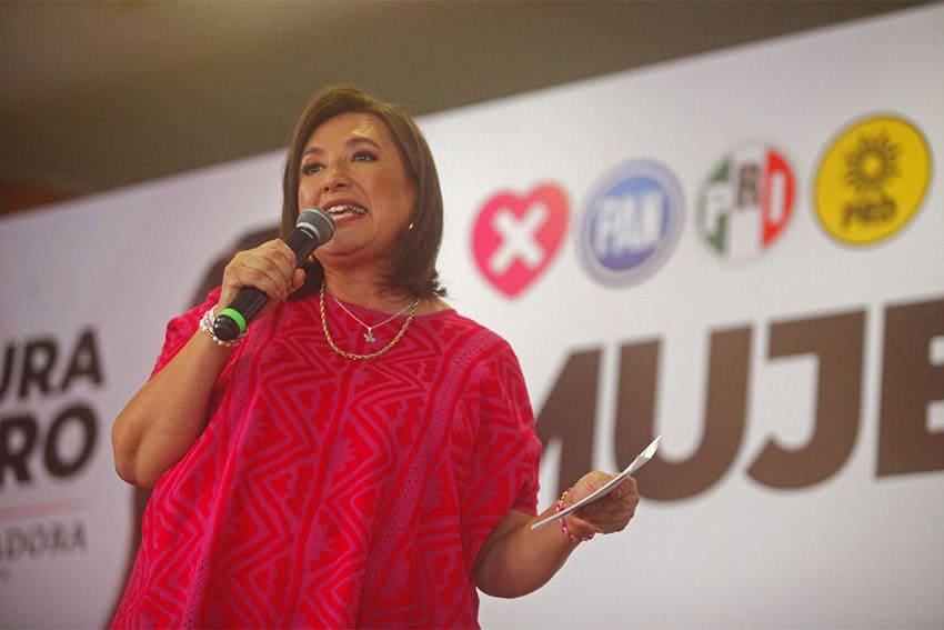 Mexico presidential candidate Xochitl Galvez holding a microphone on a stage