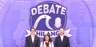 The three mayoral candidates standing in front of a sign for the second debate