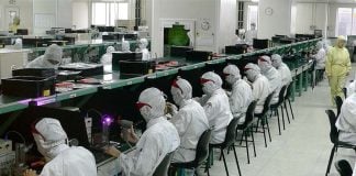 Rows of seated workers at a Foxconn electronics factory in Shenzhen, China