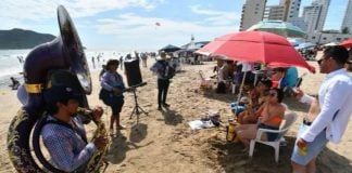 Banda musicians play for tourists on the beach in Mazatlán.