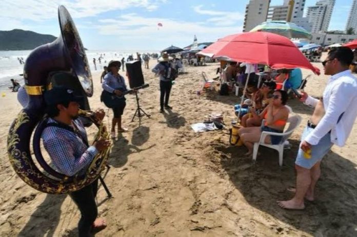 Banda musicians play for tourists on the beach in Mazatlán.