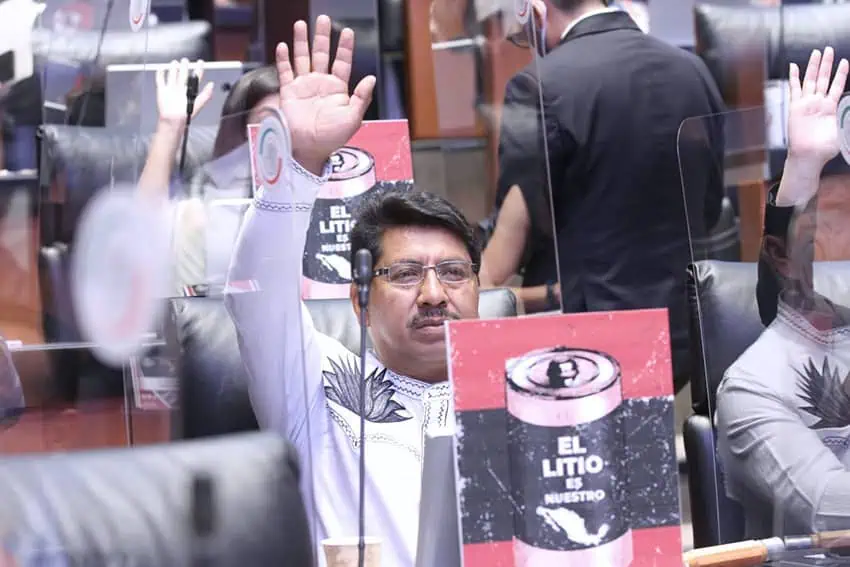 Mexico's Senator Adolfo Gomez seated, raising his hand in the Senate