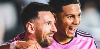 Soccer star Lionel Messi watching a play on the field with an Inter Miami teammate