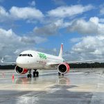 A VivaAerobus airlines plane parked on the runways at Tulum International Airport