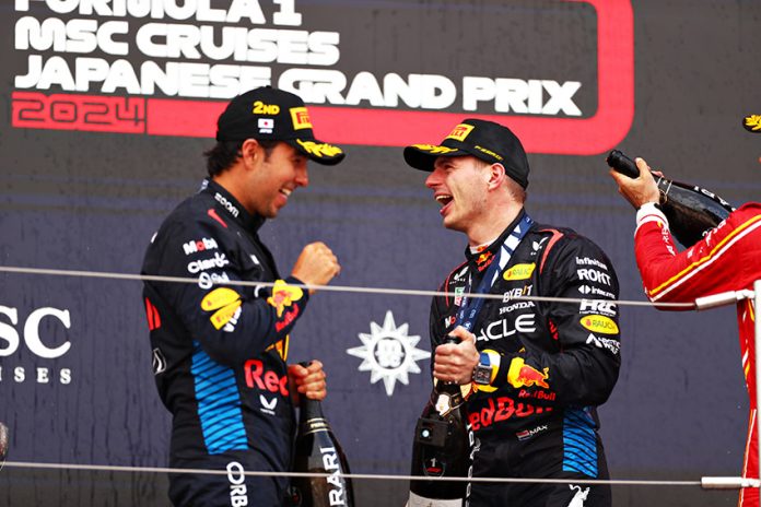 Checo Pérez celebrates with Red Bull teammate and race winner Max Verstappen in Japan