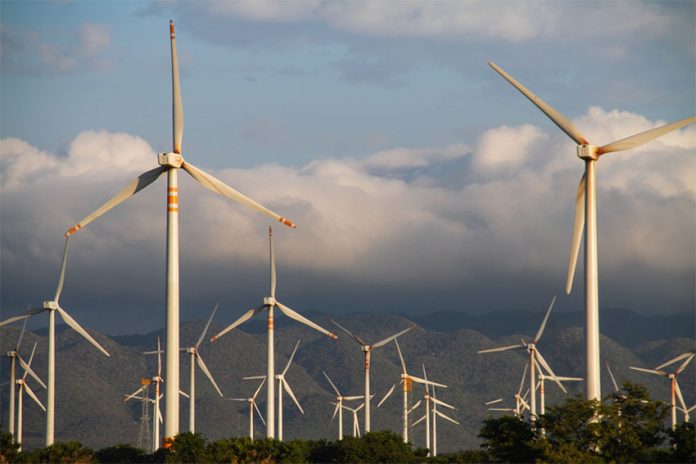 Modern windmills along a mountainous backdrop in Oaxaca, Mexico