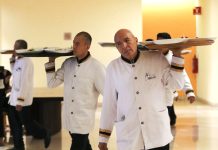 Waiters carrying trays in a hotel