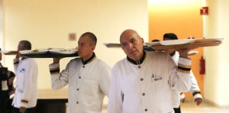 Waiters carrying trays in a hotel