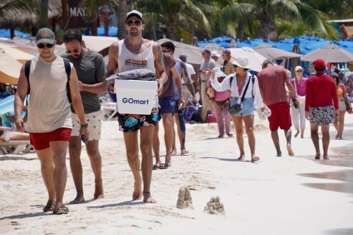 Mexican and international tourists enjoy the white sand beaches of Islas Mujeres, in April.