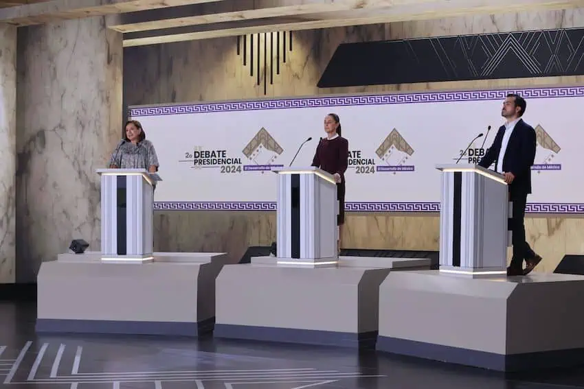 The presidential candidates at podiums on stage for debate