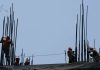 Construction workers setting up the metal support rods to a building, an image to illustrate foreign investment in Mexico