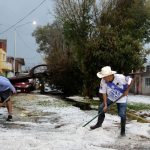 Puebla residents shovel hail that seemingly struck out of nowhere on Saturday.